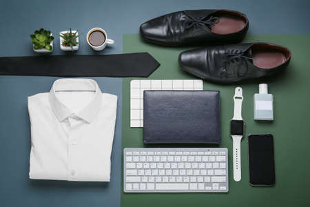 Stylish male clothes with accessories and modern gadgets on color backgroundの写真素材