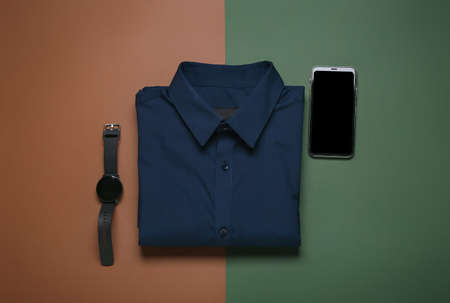 Stylish male shirt and gadgets on color backgroundの写真素材