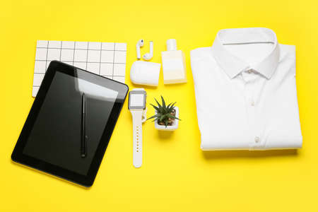 Stylish shirt, modern gadgets and accessories on color backgroundの写真素材