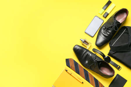 Set of stylish male accessories, mobile phone and classic leather shoes on color backgroundの写真素材