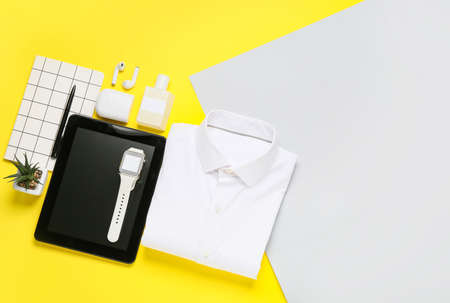 Stylish shirt, modern gadgets and accessories on color backgroundの写真素材