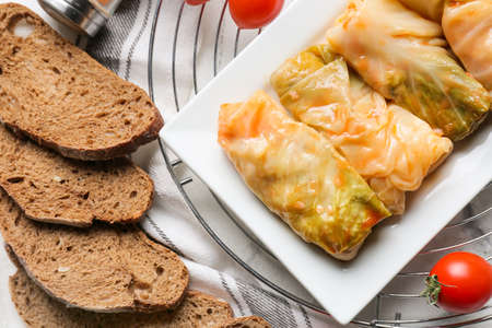 Composition with tasty stuffed cabbage rolls on light backgroundの写真素材