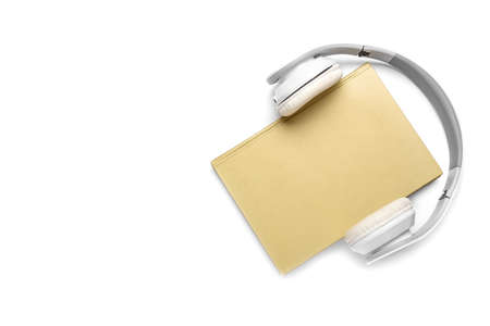 Modern headphones with book on white backgroundの写真素材