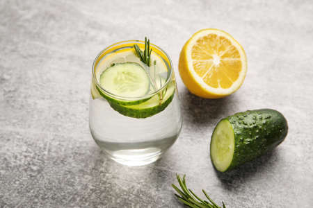 Glass with cucumber lemonade on gray backgroundの写真素材
