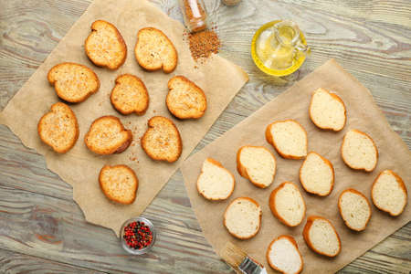 Slices of fresh and toasted bread on wooden backgroundの写真素材