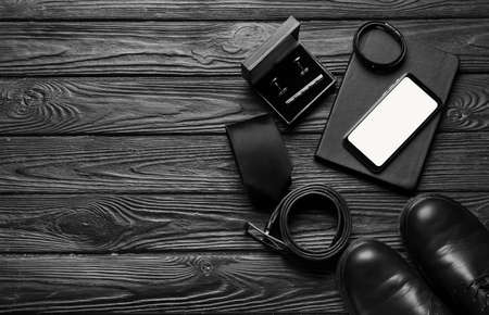 Set of stylish male accessories on dark wooden backgroundの写真素材