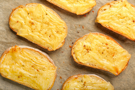 Tasty toasts with cheese on parchmentの写真素材