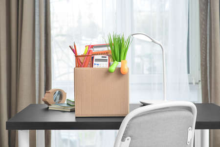 Box with personal stuff on table in office