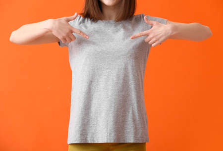 Young woman in modern t-shirt on color background