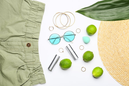 Composition with female accessories, clothes and limes on white background, closeupの写真素材