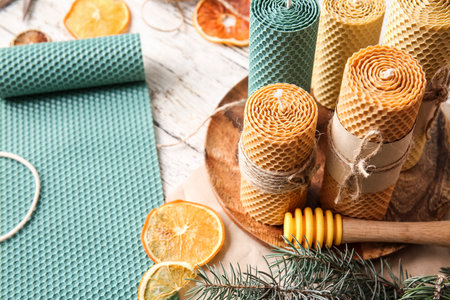 Handmade wax candles on light wooden backgroundの写真素材