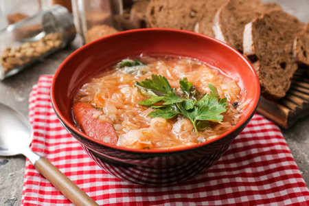 Bowl with tasty sauerkraut soup on tableの写真素材
