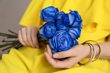 Woman with beautiful blue roses, closeupの写真素材