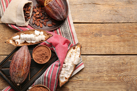 Composition with fresh cocoa fruits, beans and powder on wooden backgroundの写真素材