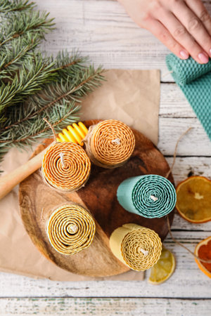 Handmade wax candles on light wooden backgroundの写真素材