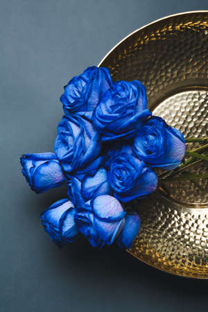 Plate with beautiful blue roses on gray backgroundの写真素材