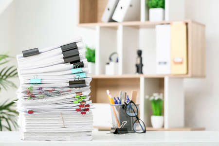 Stack of documents on table in officeの写真素材