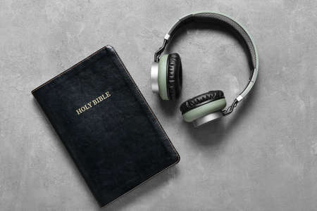 Holy Bible and modern headphones on gray backgroundの写真素材