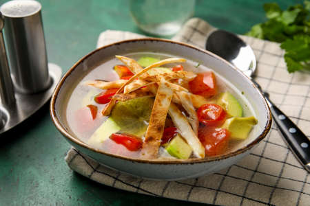 Bowl of tasty Sopa de Lima soup on tableの写真素材