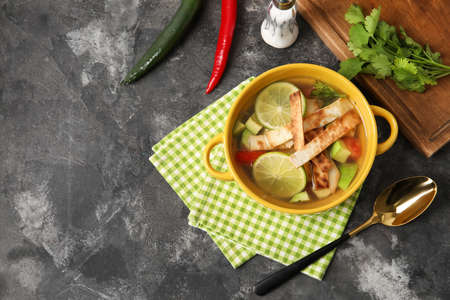 Composition with tasty Sopa de Lima soup on dark backgroundの写真素材