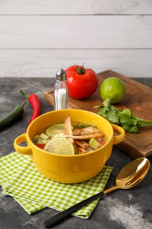 Bowl of tasty Sopa de Lima soup on tableの写真素材