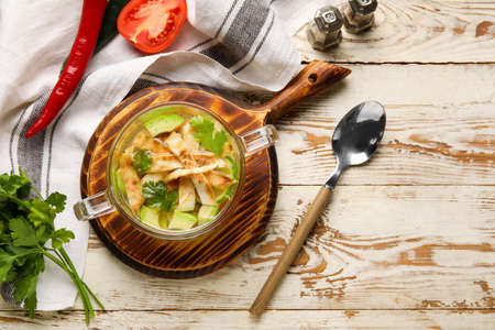 Composition with tasty Sopa de Lima soup on light wooden backgroundの写真素材