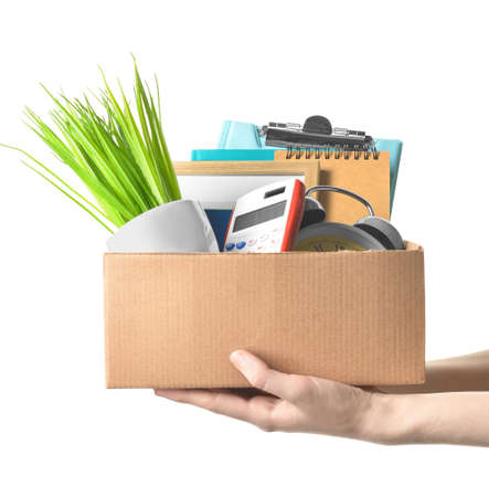 Woman holding cardboard box with personal stuff on white background