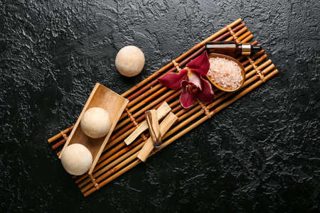 Beautiful spa composition with Palo Santo on dark background