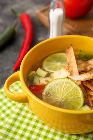 Bowl of tasty Sopa de Lima soup on table, closeupの写真素材
