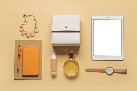 Stylish female accessories and tablet computer on yellow backgroundの写真素材