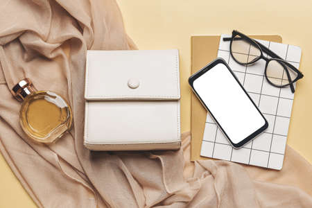 Stylish female accessories and mobile phone on color backgroundの写真素材