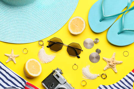 Set of beach accessories and lemon on color backgroundの写真素材