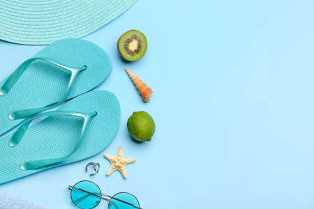 Beach accessories and fruits on color backgroundの写真素材