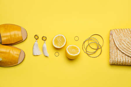 Set of female accessories and lemon on color background