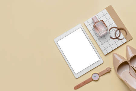 Stylish female accessories and tablet computer on yellow backgroundの写真素材