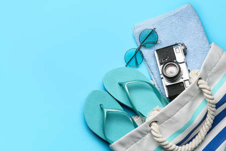 Bag with beach accessories on color backgroundの写真素材