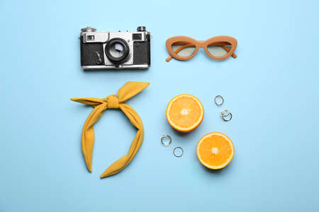 Female accessories, photo camera and orange on color backgroundの写真素材