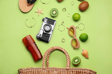 Set of beach accessories and fruits on color backgroundの写真素材