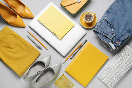 Female clothes, accessories and modern gadgets on light background, closeup
