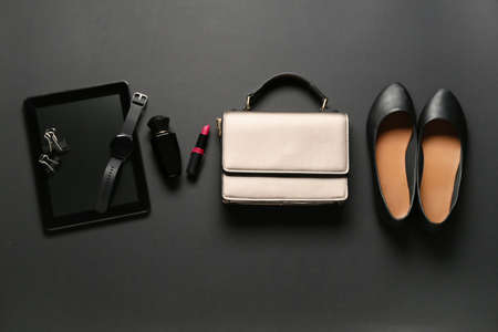 Stylish female accessories and tablet computer on dark backgroundの写真素材
