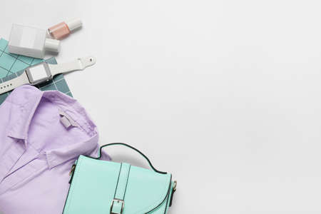 Stylish female accessories, shirt and modern smartwatch on white backgroundの写真素材