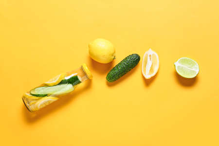 Bottle with cucumber lemonade on color backgroundの写真素材