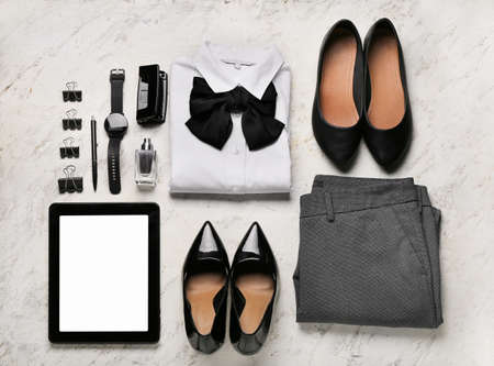 Stylish female clothes, accessories and modern gadgets on light backgroundの写真素材