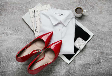 Stylish female clothes, accessories and modern gadgets on gray backgroundの写真素材