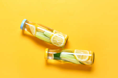 Bottles with cucumber lemonade on color backgroundの写真素材