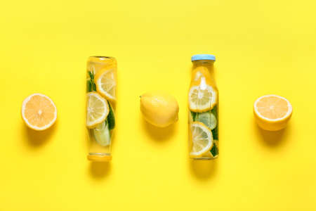 Bottles with cucumber lemonade on color backgroundの写真素材