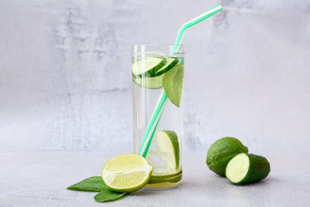 Glass with cucumber lemonade on light backgroundの写真素材