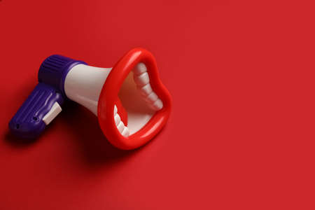 Toy megaphone on red backgroundの写真素材