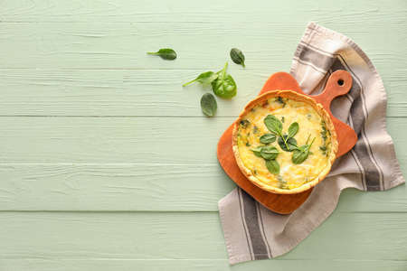 Tasty spinach tart on color wooden backgroundの写真素材