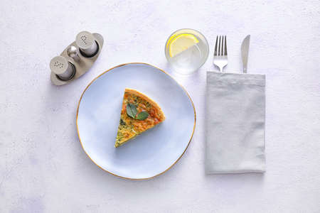 Table setting with spinach tart on light background